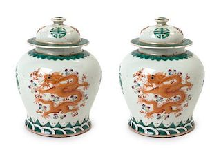 A Pair of Famille Verte Porcelain Jars and Covers Height of pair 8 1/4 inches.