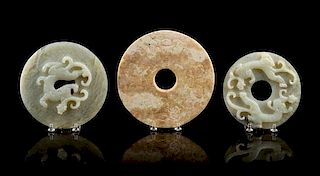 * A Group of Seven Carved Jade Bi Discs Diameter of largest 9 inches.