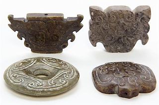 * A Group of Three Carved Jade Toggles Width of widest 2 5/8 inches.