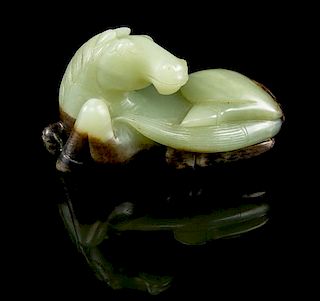 * A Carved Jade Figure of a Horse Width 4 1/2 inches.