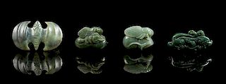 * A Group of Four Spinach Jade Pendants Length of largest 2 1/2 inches.