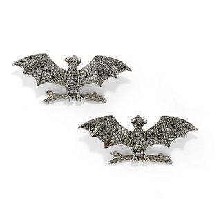 A couple of 18K burnished white gold and black diamond brooches