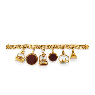 A 14K yellow gold and gemstone charms bracelet