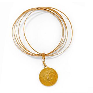 A 18K yellow gold bangle with pendant