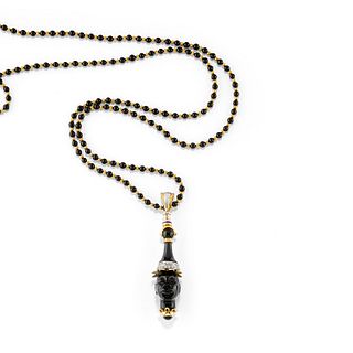 A two-color gold, diamond and onyx necklace