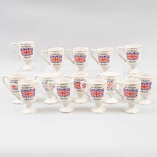 Lot of 13 cups. 20th century. Porcelain. Decorated with gold enamel, Union Jack crest and "Sir Winston Churchill" inscription.