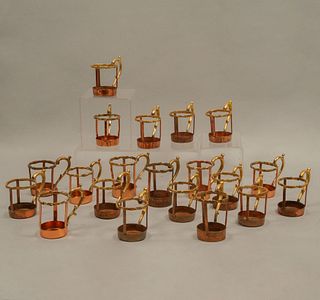 Lot of 20 cup holders. 20th century. Made in copper and brass. Decorated with organic elements.