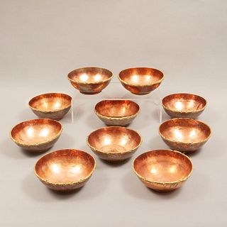 Lot of 10 bowls. 20th century. Made in copper. Decorated with organic elements and brass applications.