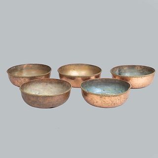 Lot of 5 planters. 20th century. Made in copper. With lead weights in bases. Decorated with geometric elements.