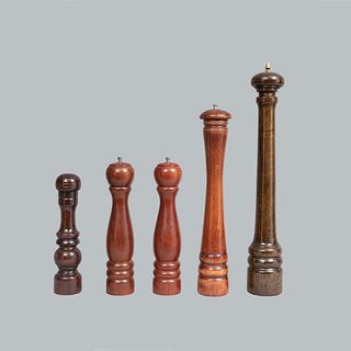 Lot of 5 pepper shakers. Twentieth century. In wood carving. Decorated with ringed elements and metal applications.
