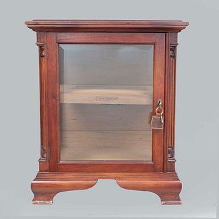 Cigar humidifier. United States. Twentieth century. Cigar Chest Co. brand. Wood carving. With hinged glass door.
