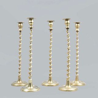 Lot of 5 candlesticks. Twentieth century. Made in brass. With circular washers, wound shafts and circular supports.