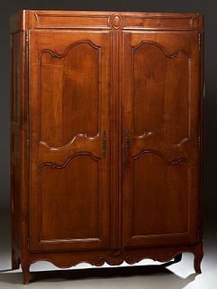 French Louis XV Style Carved Oak Armoire, early 19th c., the stepped cavetto crown over double fielded panel doors with long brass e...