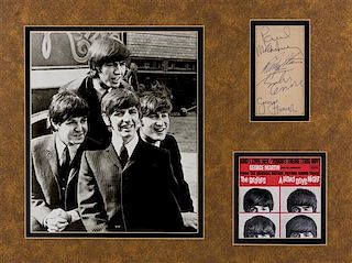 * (THE BEATLES) Autographed note card signed in pen by all four members. Framed and matted with repro photo.