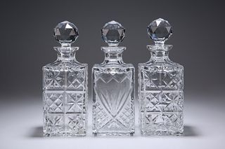 THREE LARGE SQUARE-SECTION GLASS DECANTERS. 26.5c