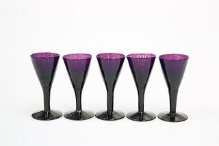 A SET OF FIVE AMETHYST GLASS PORT OR SHERRY GLASS