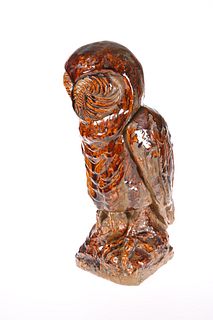 A LARGE TREACLE-GLAZED POTTERY MODEL OF AN OWL, m