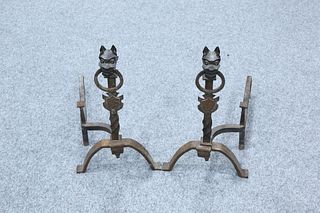 A PAIR OF WROUGHT IRON FIRE DOGS, each beast cast