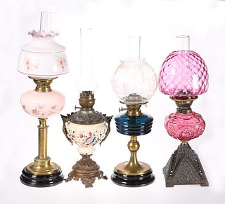 FOUR VICTORIAN OIL LAMPS, the first with cranberr