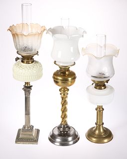 THREE VICTORIAN OIL LAMPS, the first with silver-