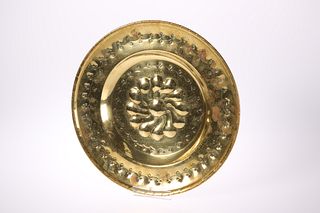 A BRASS ALMS DISH, 19TH CENTURY, embossed with a 