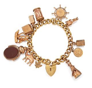 A GOLD-PLATED CHARM BRACELET, charms include towe