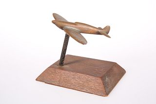 A TRENCH ART METAL MODEL OF A SPITFIRE, on a wood