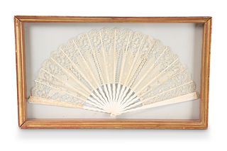 A 19TH CENTURY LACE AND IVORY FAN, in a glazed di