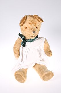 A VINTAGE TEDDY BEAR, straw stuffed. 63cm