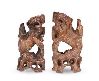 A PAIR OF CHINESE ZITAN FOO DOGS, each carved ope