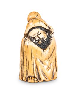 A CHINESE MAMMOTH IVORY CARVING OF A SLEEPING SCH