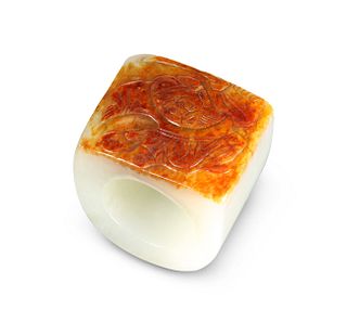 A CHINESE JADE THUMB RING, decorated in shallow r