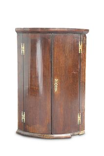 A GEORGE III OAK BOW-FRONT CORNER CUPBOARD, with 