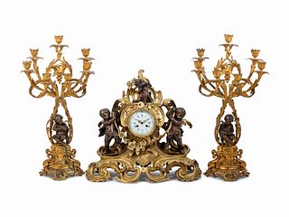 A Louis XV Style Gilt and Patinated Bronze Clock Garniture