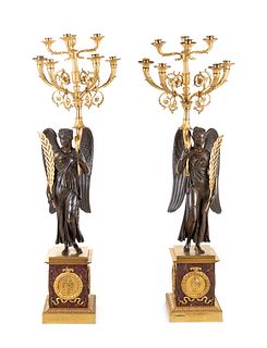 A Pair of Large Empire Style Gilt and Patinated Bronze Figural Eight-Light Candelabra