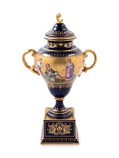 A Vienna Style Painted and Parcel Gilt Porcelain Covered Urn on Stand