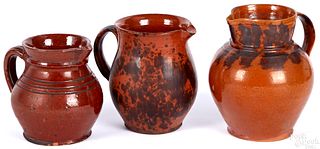 Three Pennsylvania redware pitchers