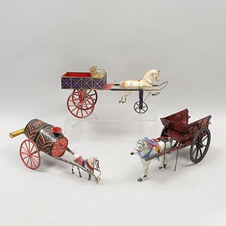 Lot of 3 toy carriages. 20th century. Made of polychrome sheet. Each one includes a toy horse.