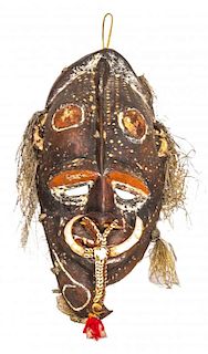 A Sepik River Region Painted and Carved Hardwood Mask, Papua New Guinea, Early 20th Century.