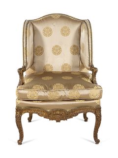 A Louis XV Style Carved and Giltwood Fauteuil a Oreilles