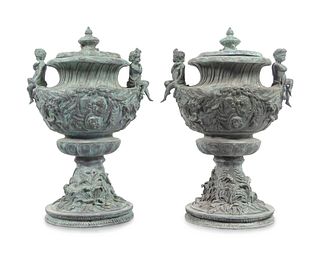 A Pair of Louis XV Style Cast Iron Covered Garden Urns