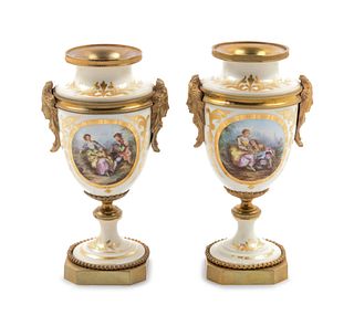 A Pair of Sevres Style Gilt Bronze Mounted Painted and Parcel Gilt Porcelain Urns