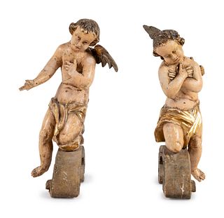 A Pair of Continental Carved, Parcel Gilt and Polychrome Painted Cherub Figures