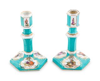 A Pair of Berlin (K.P.M.) Painted and Parcel Gilt Porcelain Candlesticks