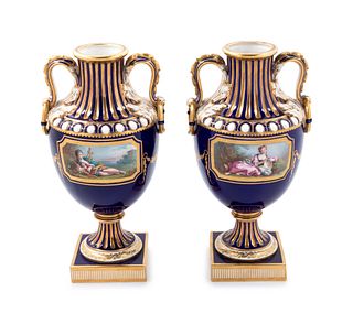 A Pair of Minton Painted and Parcel Gilt Porcelain Urns