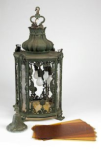 A patinated bronze hanging garden lamp