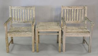 Three piece outdoor teak lot to include 2 armchairs and a side table, ht. 21", top 21" x 21".