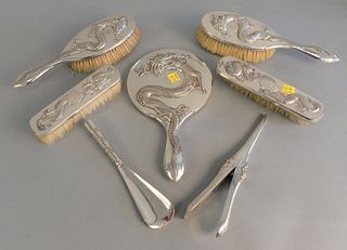 Seven piece Chineses silver dresser set to include 3 pieces marked Zee Sung, 4 brushes, mirror, lg. 10", shoehorn and hair curler, all with 3 claw dra