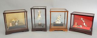 Four Japanese silver pieces in glass cases to include figure holding fan, figure with fish and rod and a double crane with turtle figure, largest ht. 