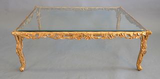 Large glass-top coffee table having carved composite gilded base, ht. 17", top 31" x 51".